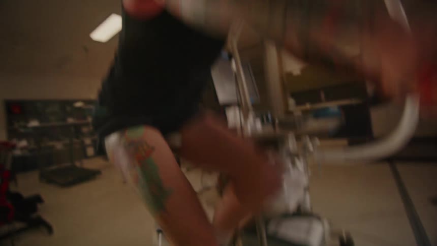 A man ridding and exercising on a cardio bike