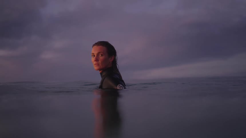 A woman in the sea during the cloudy evening