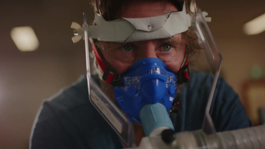 A portrait of a man with an oxygen mask undergoing an oxygenation test with physical exertion