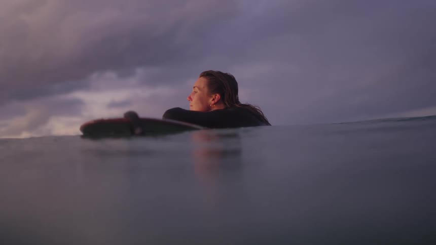 Beautiful young women contemplating in the surf