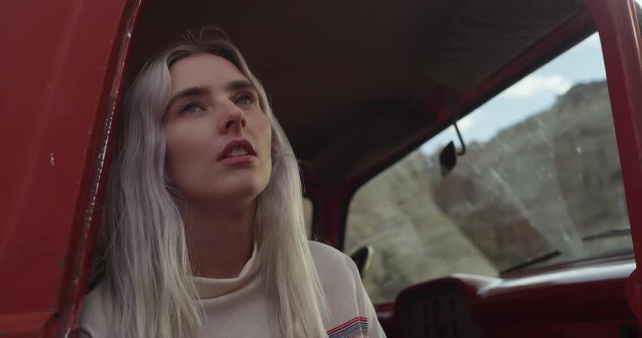 Woman sitting in parked truck looking outside