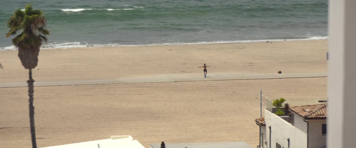 A person rollerblading on the beach during the summer