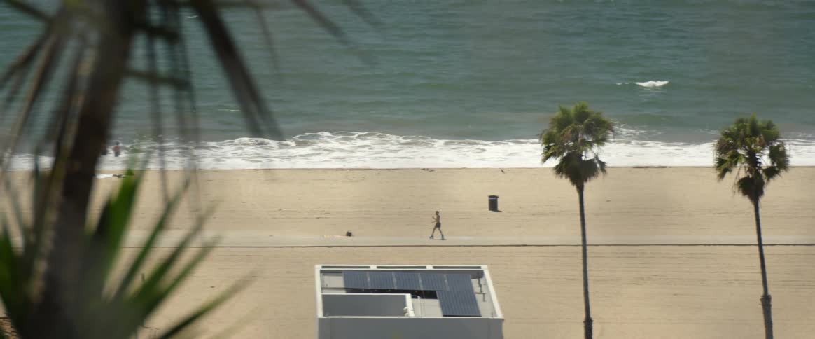 Male skater performs different moves on road near beach