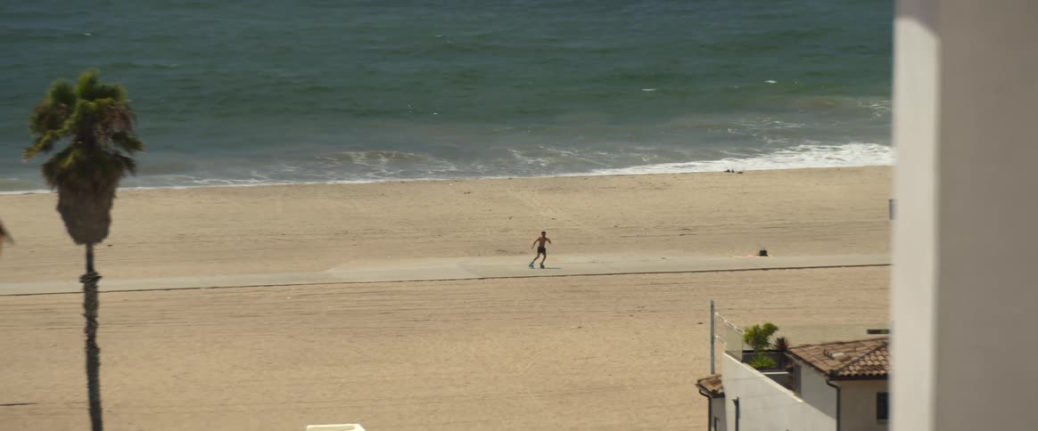 A man skate dancing beside the beach
