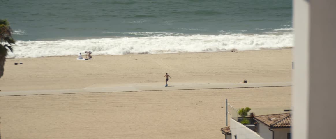 A person doing tricks with a roller skate on the beach