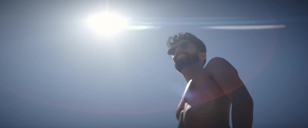A shirtless man on a sunny day
