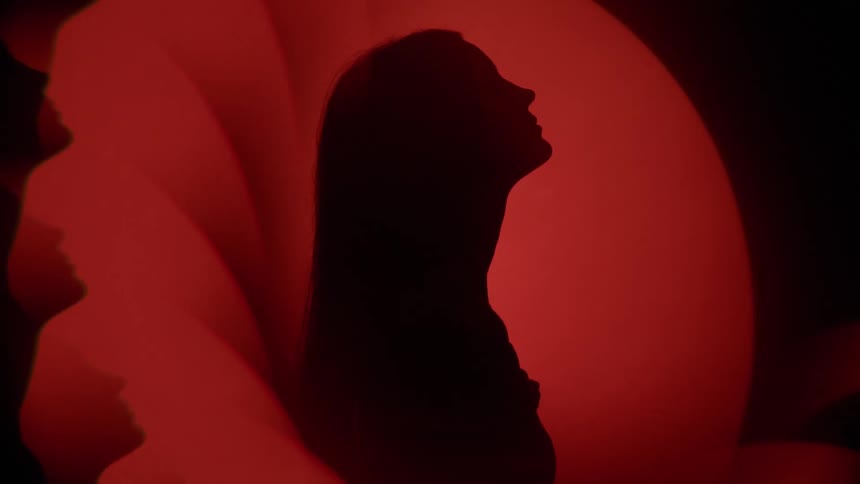 A lady standing in one spot with her head tilted backward