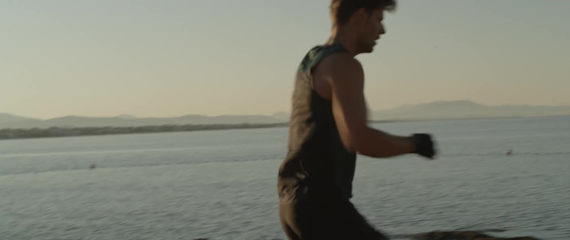 A man running beside the seashore