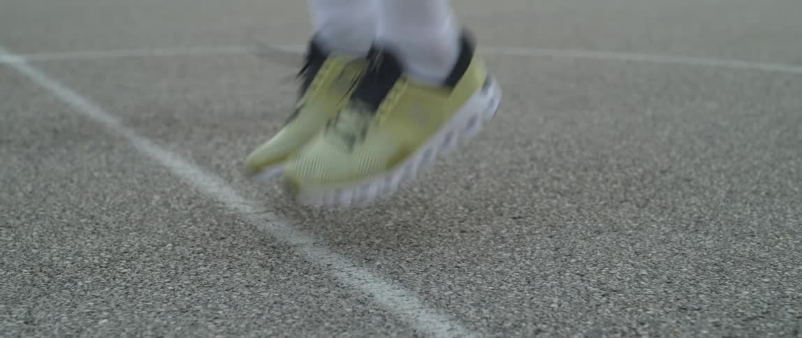 Closeup on a mans sneakers while he is jumping rope