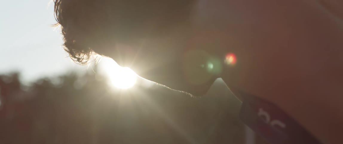 A portrait of a pensive young man with sunlight reflecting on his face