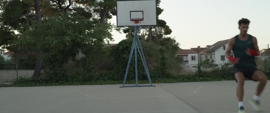 A man runs around the basketball court