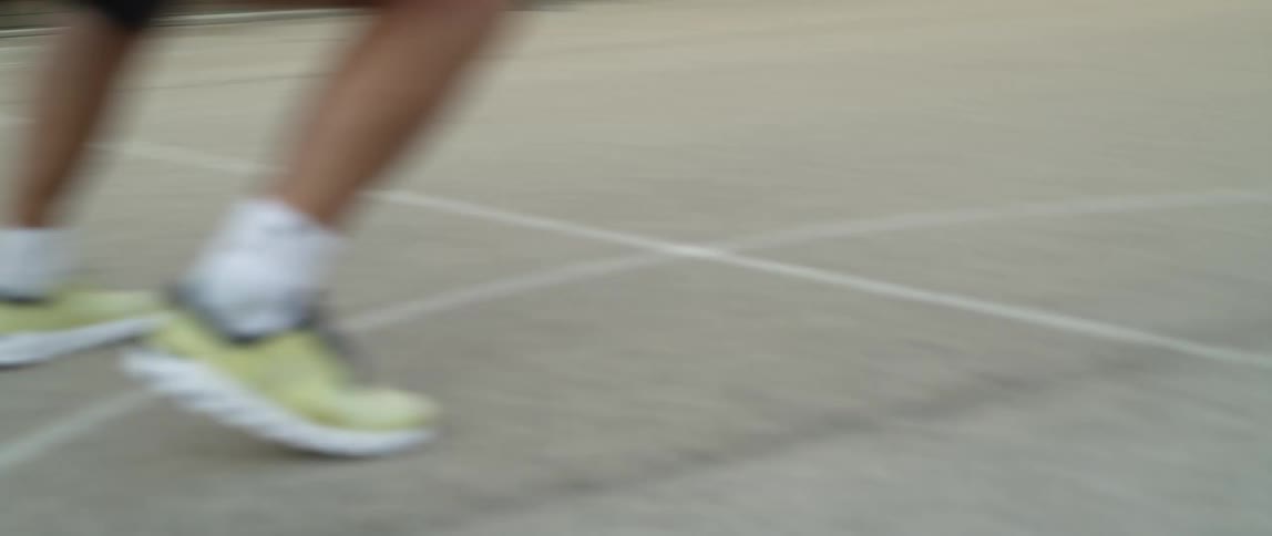 A man is running around the court