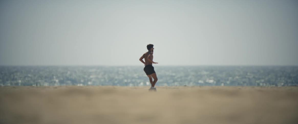 Man in shorts roller skates near the beach