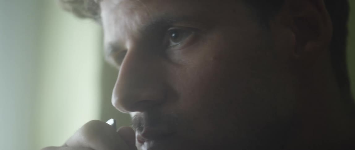 A closeup of a mans face eating