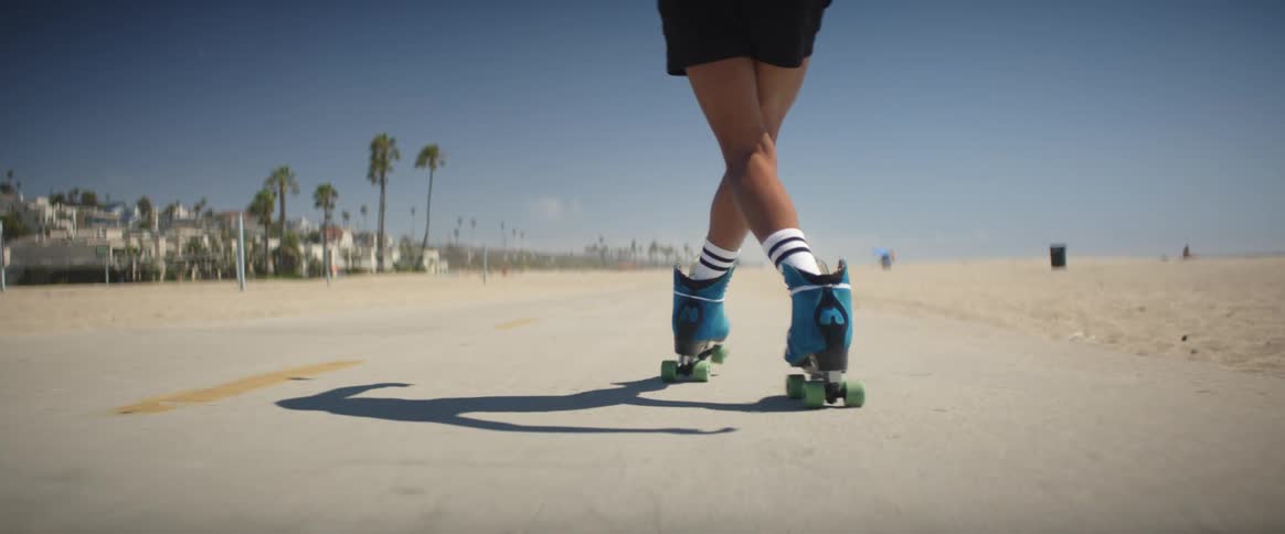 Man in shorts roller skates near the beach