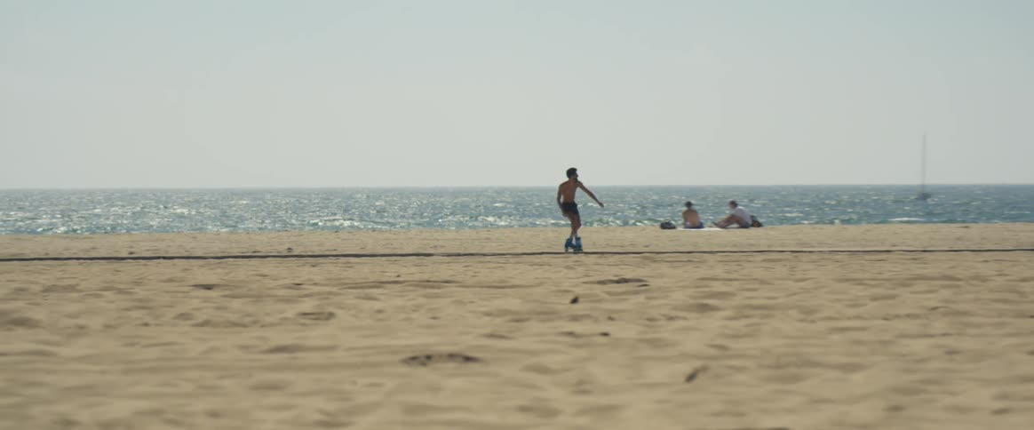 A skate dancer skating on the road by the beach