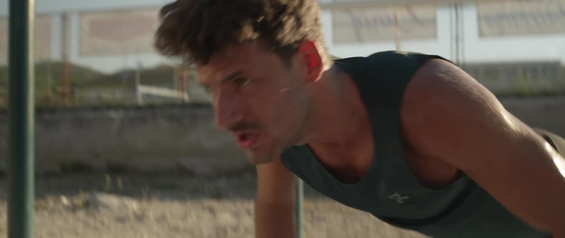 A man doing pushups in an outdoor setting
