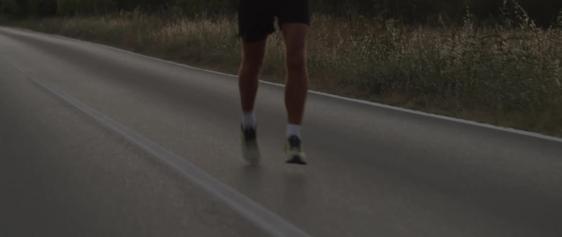 A man running on a road at dawn