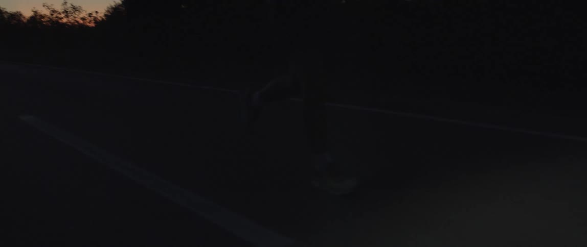 A man jogging at night with a light on his forehead