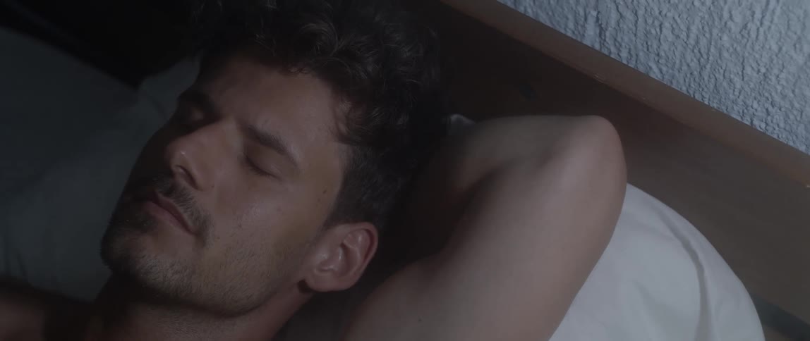 A man laying and meditating on the bed