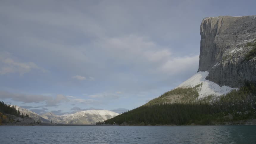 The mountains around this lake have snow on them