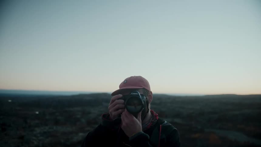 A man photographing the landscape during sunset