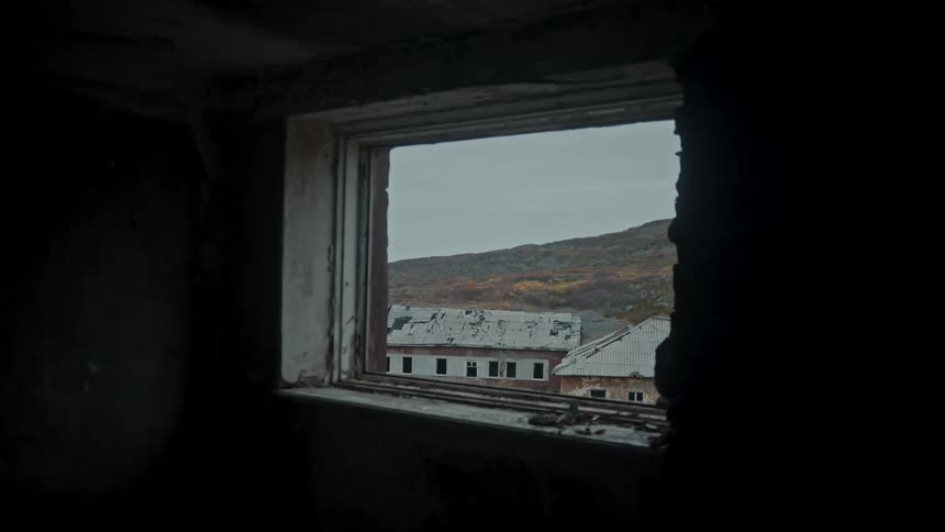 View from inside a house on the seaside with other residences on a cloudy day