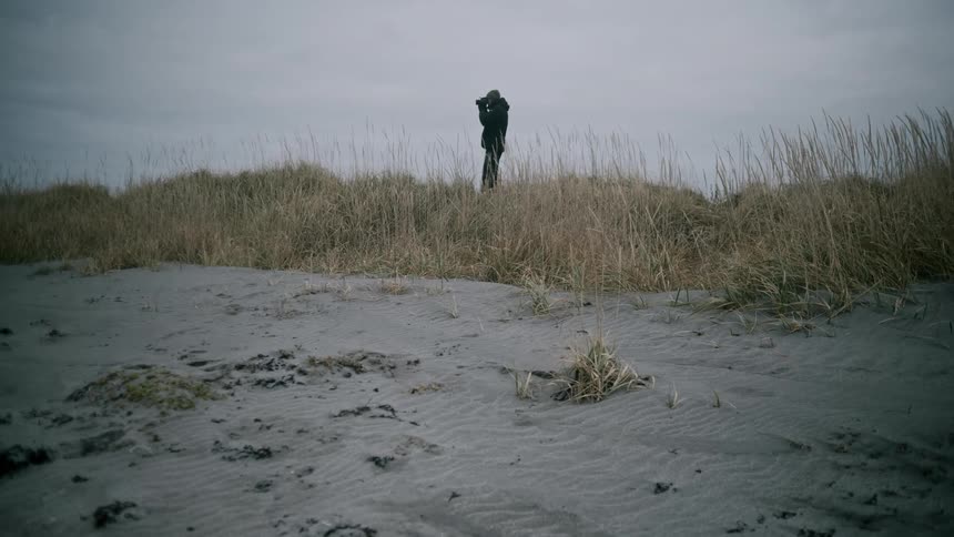 A man using binoculars to observe the landscape