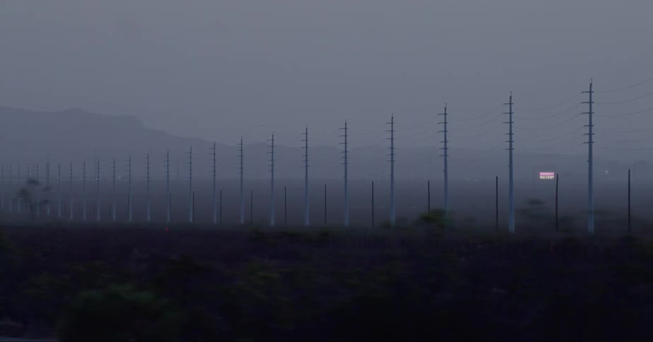 Fog covers the row of power lines