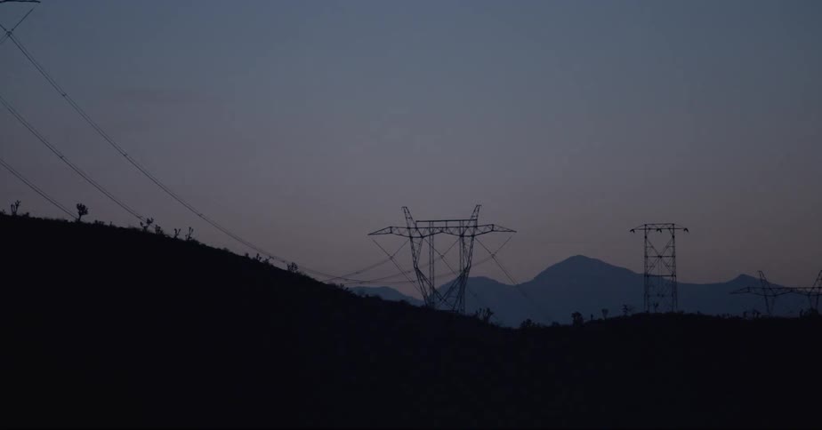 Electricity transmission towers on top of cliffs and mountains