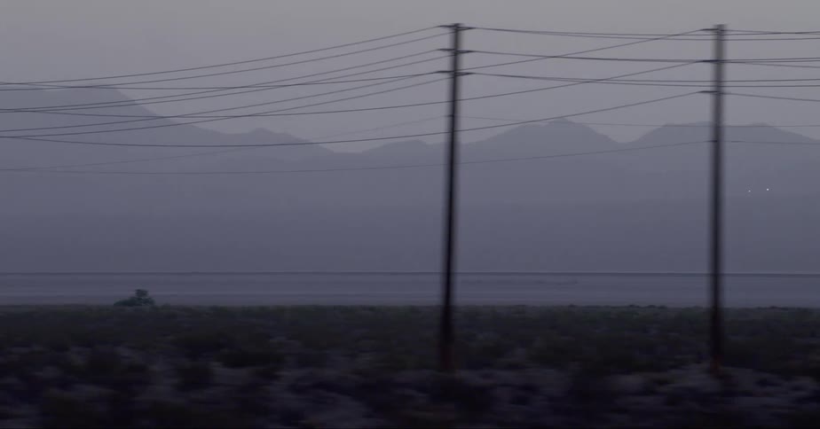 Utility poles with transmission cables at sunset