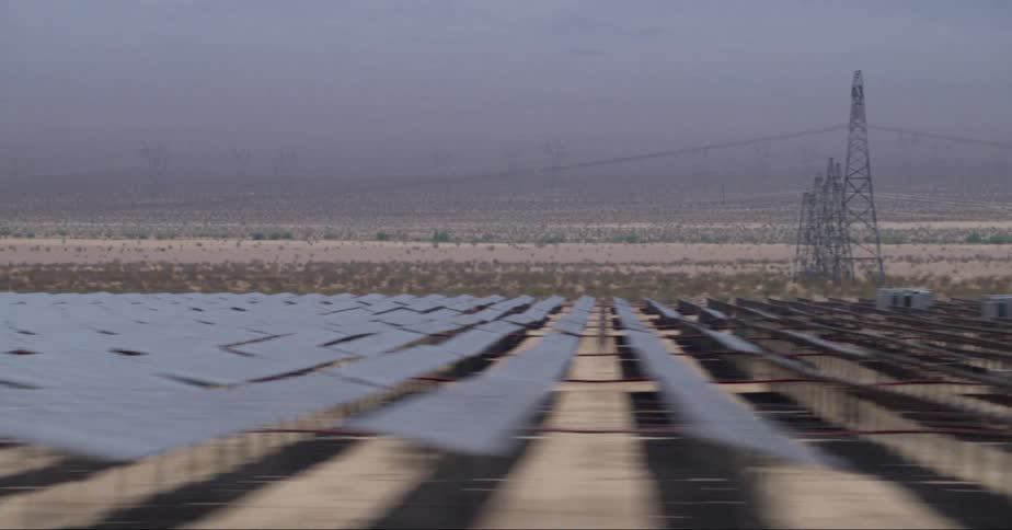 Photovoltaic solar farm in the desert seen from a moving vehicle