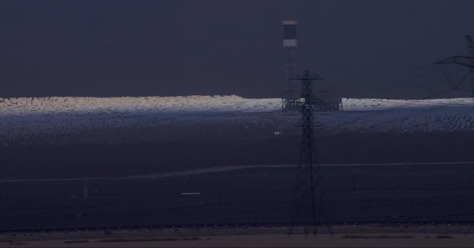 View of power towers by the roadside in an outdoor environment