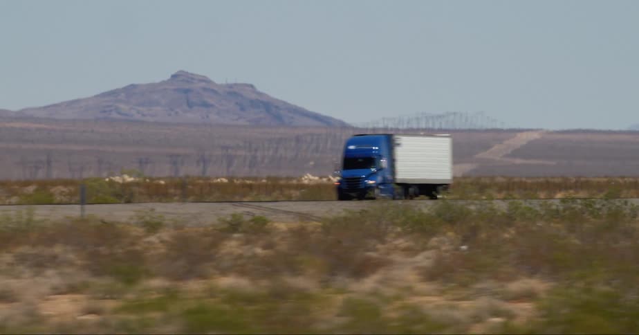 A motion video of moving truck and car on the road