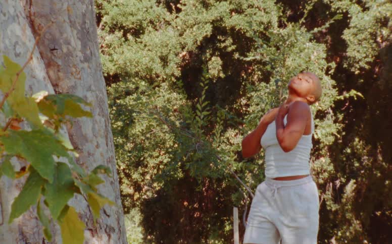 Woman dances outdoors in woods