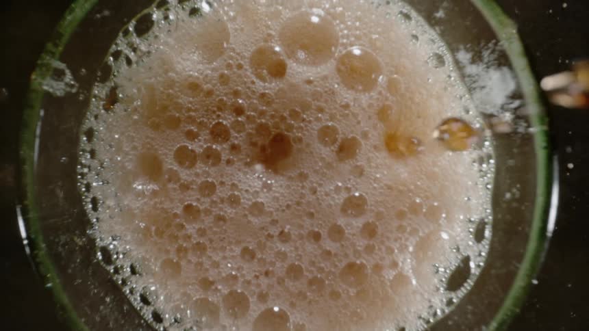 Liquid drops inside a glass cup from above