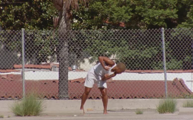 A woman dancing barefoot outdoors