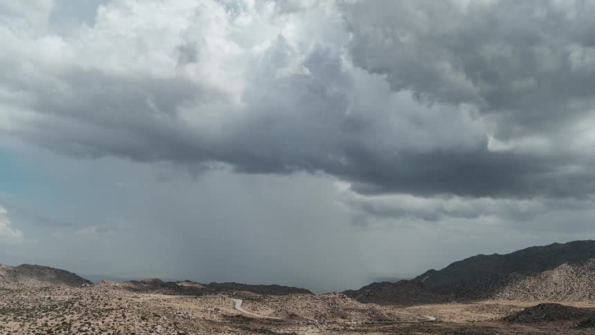 A deserted road in a wild landscape with mountains