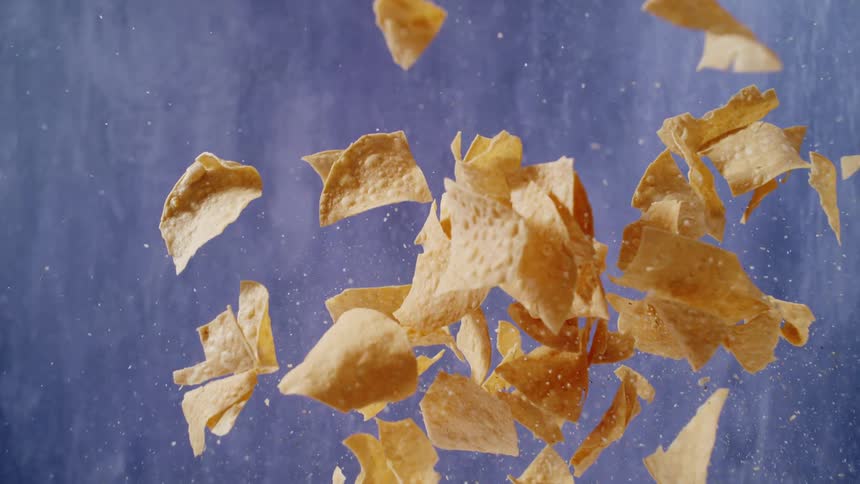 Tortilla chips nachos falling in slow motion