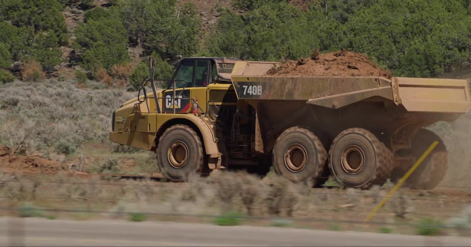 Dump truck transporting dirt on a construction site in the countryside
