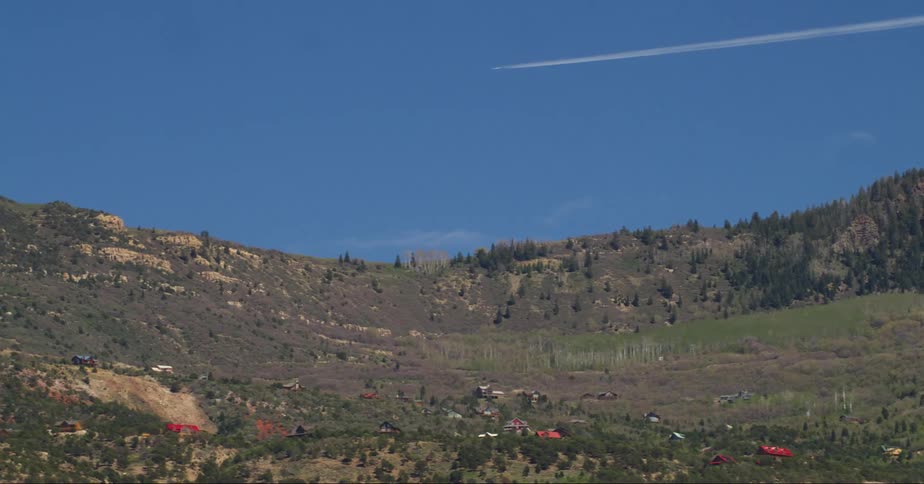 A plane flies over the mountains