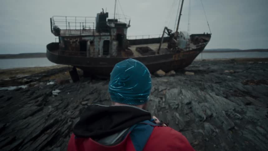 Photographer takes pictures of a rusted abandoned boat in the coast
