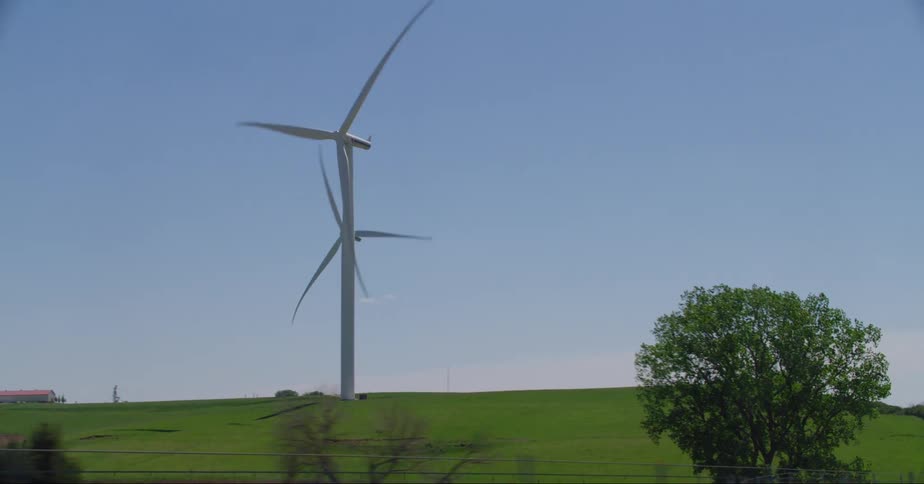 Wind turbines on wind farm seen from car driving on highway