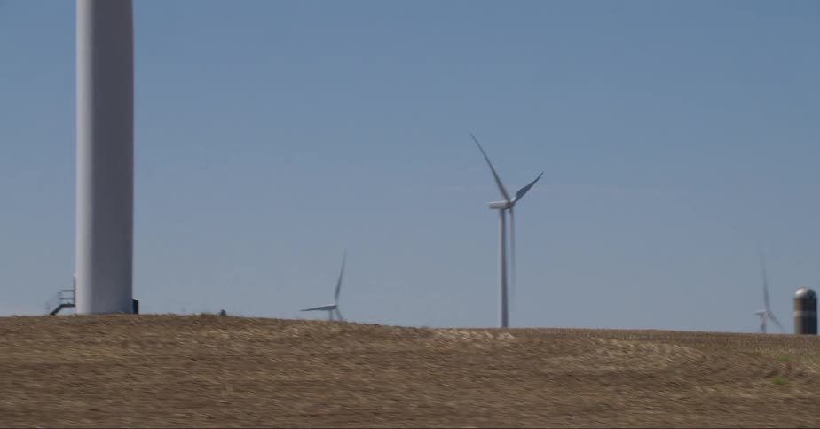 Modern windmills on a field their shadow over the ground