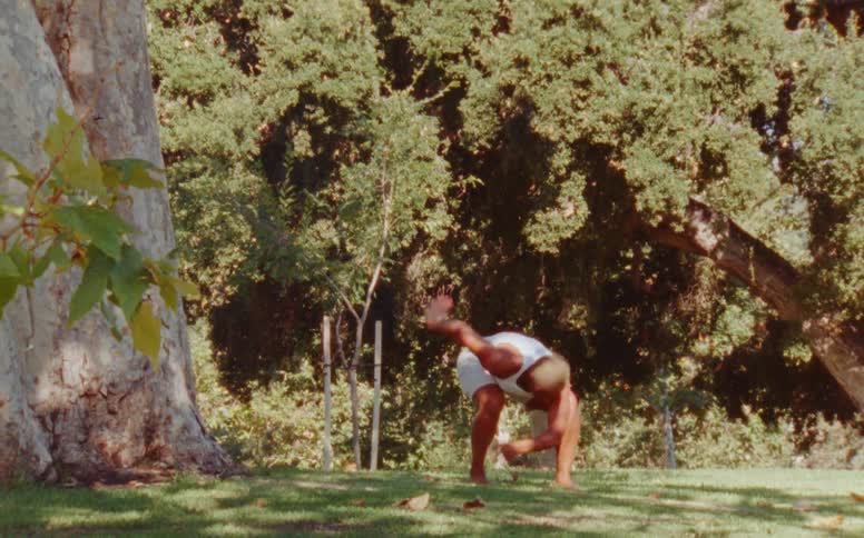Woman stretches and dances on the lawn in the backyard