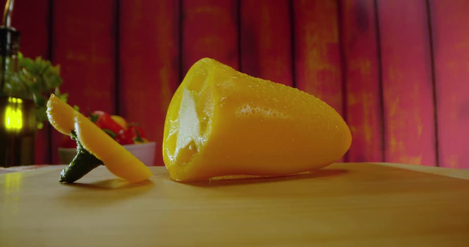 Knife cutting a yellow pepper