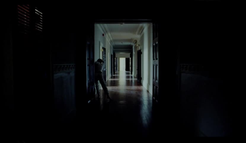 A weak man falls down on the floor in the hallway