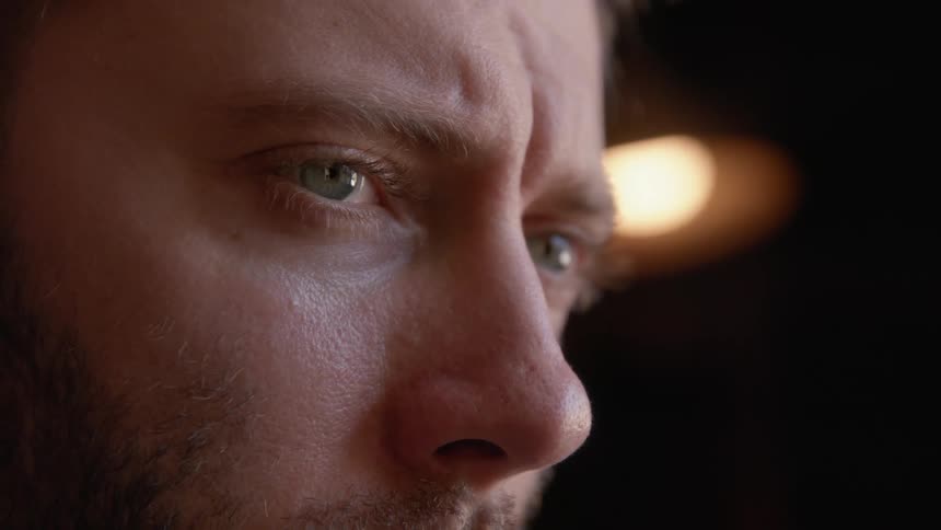 Closeup of a mans face with a sad look