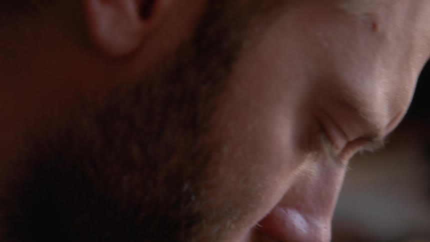 Profile of a bearded man focused on work