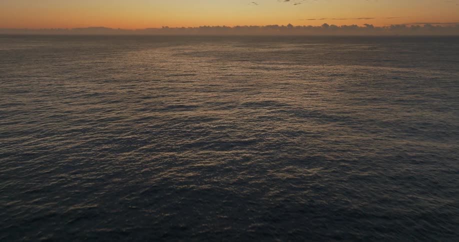 A view of the sea with an orange sky